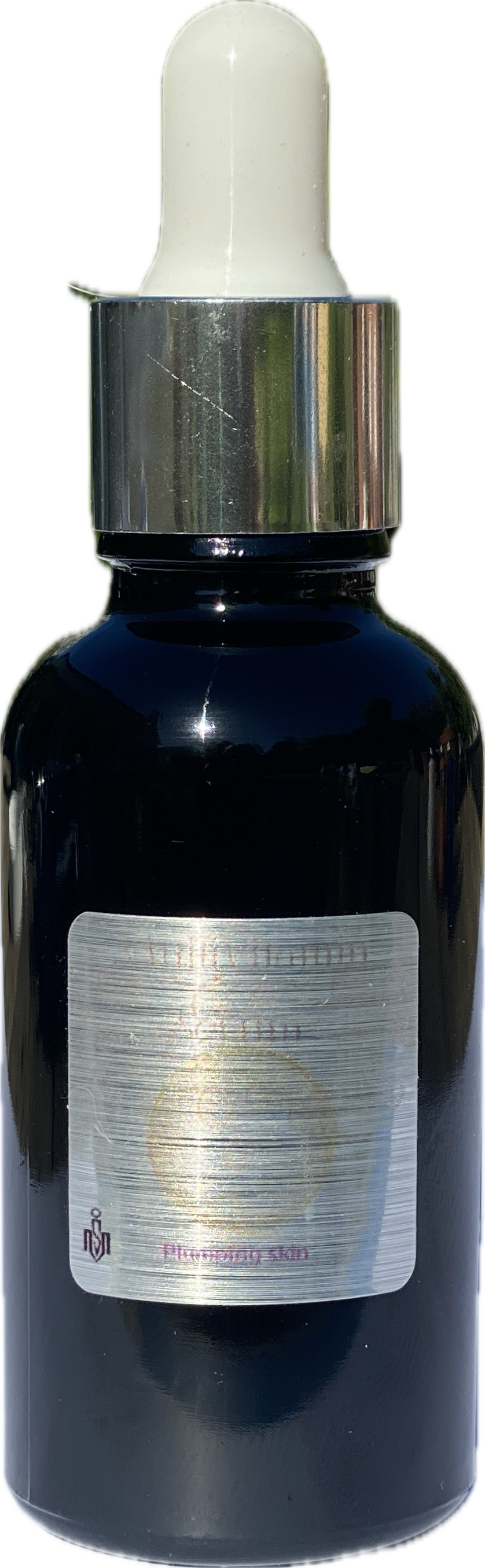 Black glass dropper bottle with a white label on a black background
